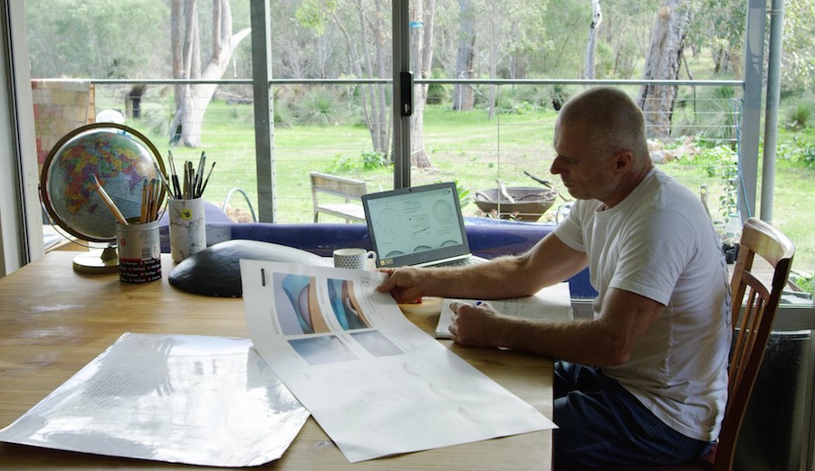 Troy at desk with drawings